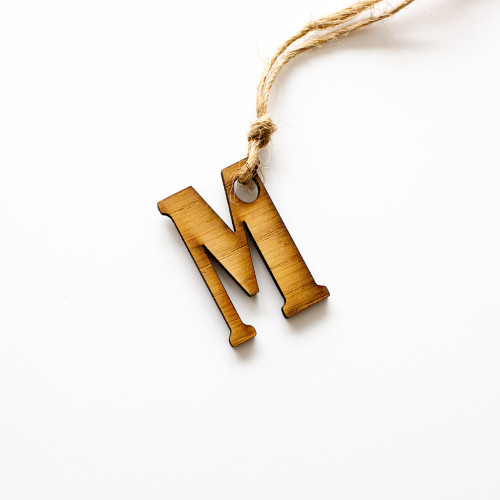 Gift tag made of wood, in the inital M, availble to purchase from The Chuckling Cheese Company