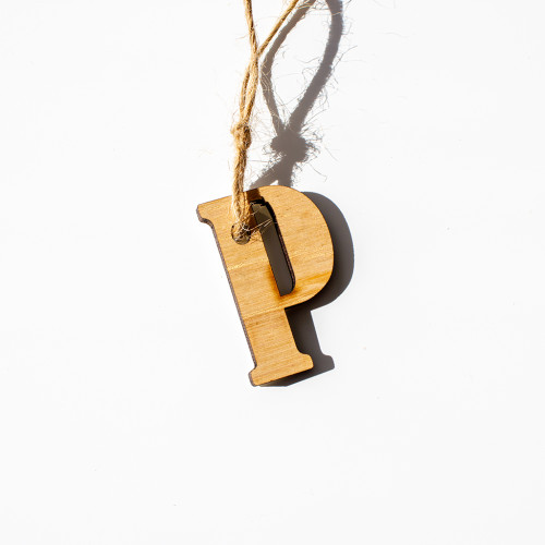 Gift tag made of wood, in the intial P, availble to purchase from the Chuckling Cheese Company