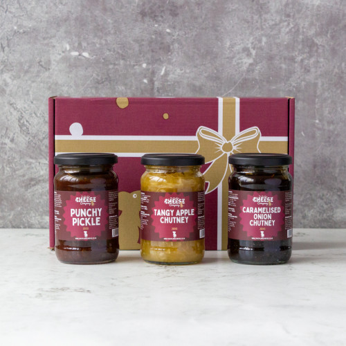 Grey background image of Chutney Gift Pack 1 containing three jars of traditional chutney, punchy pickle, tangy apple, and caramelised onion.