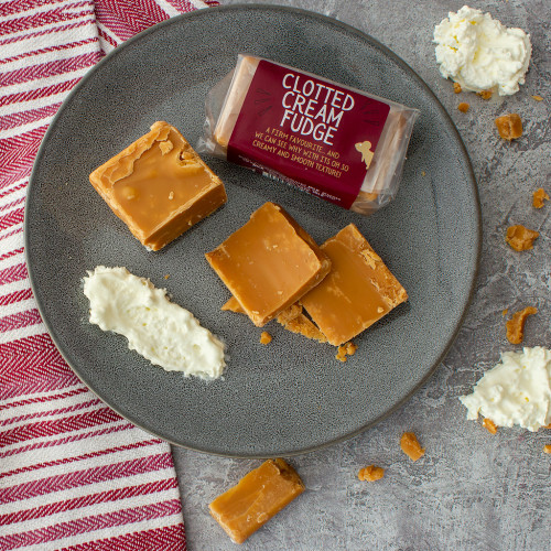 Lifestyle image of a Clotted Cream Fudge Bar on a plate with cream