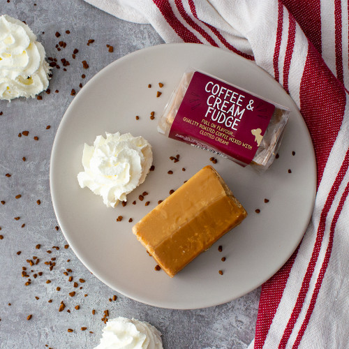 Lifestyle image of a Coffee and Cream Fudge Bar decorated with whipped cream