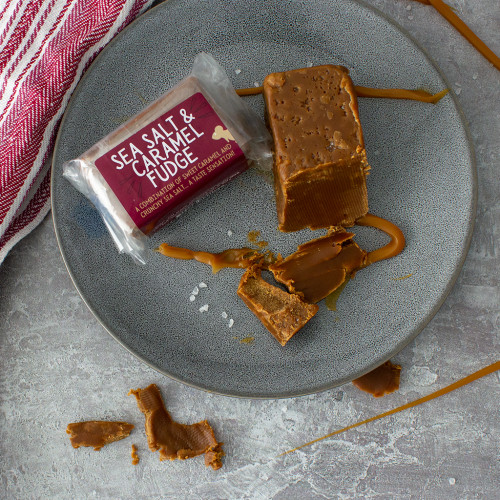 Lifestyle image of a Sea Salt and Caramel Fudge Bar decorated with caramel sauce and sea salt